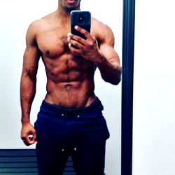 Fit and Muscular Man in Gym Wear, Showing Abs