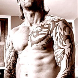 Fit and Muscular Man in Tattooed Tank Top