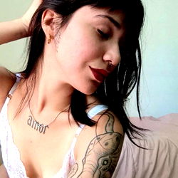 Emma, a captivating model with striking tattoos