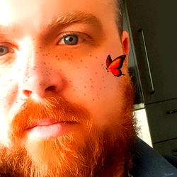 Angus, a Red-Haired Gentleman with Freckles and a Butterfly Tattoo on His Forehead