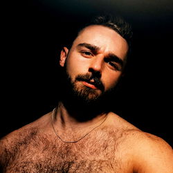 Fashionable Londoner E Black with Groomed Beard and Tattoo, Showcasing Muscular Physique