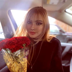 A Model with Red Rose in Car
