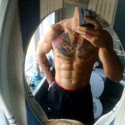 Josh Andrews Fitness Model Showcasing Abs and Tattoos
