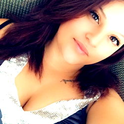 Lovelyydriaa, a California-based OnlyFans model posing for the camera with her head out of frame.