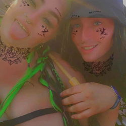 Two Girls in Tie-Dye Outfits with Colorful Face Paint