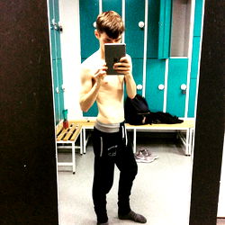 Fitness Model Boyjordan Showcasing His Transformation in Gym Mirror