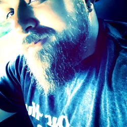 A Bearded Man in a Vehicle, Striking a Pose