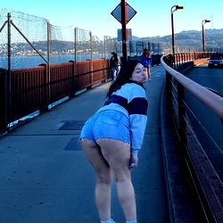 A model posing for a photo on a bridge
