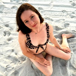 Amelia C Ross, the model posing in a bikini on a beach