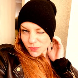 Stylish and Confident Mischa Malina in a Leather Jacket and Black Beanie