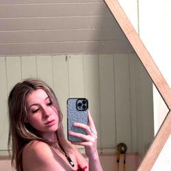 Social Media Influencer in Red Bathing Suit Taking a Selfie