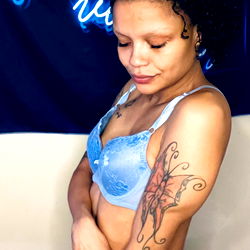 A Model Posing in a Blue Bra