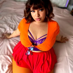 OnlyFans Model Jay Doll in Colorful Outfit on Bed