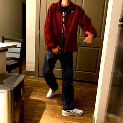 Man in Red Jacket Dancing in Kitchen with Open Door
