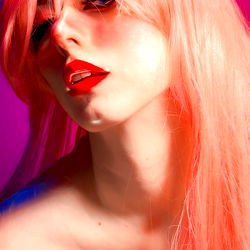 Vivid Cosplay Character in Pink with Red Hair and Lipstick