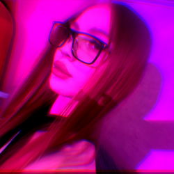 Colorful OnlyFans Model in a Vivid Pink Room