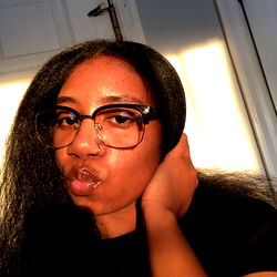 Woman in Sunglasses and Black Shirt with Her Hair Up