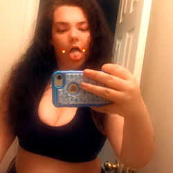 Angie in a bathroom mirror with tattoos