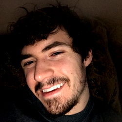 Smiling man with beard, relaxed pose