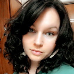 Smiling Woman with Short Dark Hair and Curly Earrings