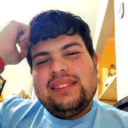 Man in a Blue Shirt Resting his Chin on Hand