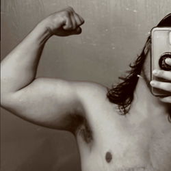 Shirtless OnlyFans Model Showing Off Muscles with Phone