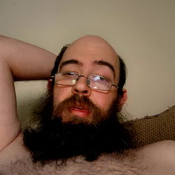 A Man Relaxing in a Shirt and Glasses