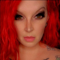 Red-haired OnlyFans model with striking eyes and a piercing gaze, LexieRae0724, from Texas