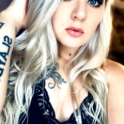 T Raven from OnlyFans, Striking a Pose with Tattoo