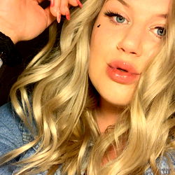 Lexi - Onlyfans model captured in a candid moment, showcasing her unique style. She is seen wearing a casual outfit and playfully interacting with the camera.