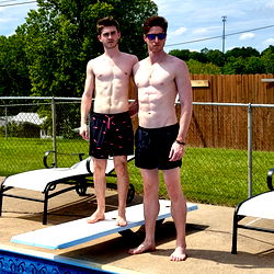 A pair of fit individuals by a pool