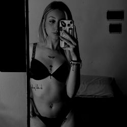 Sofia, a 23-year-old model from OnlyFans, posing in a bedroom setting.