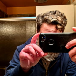 Person taking selfie in bathroom mirror