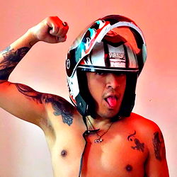 Fitness Model Posing in a Biker's Helmet