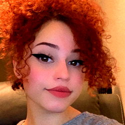 Curley Head model, showcasing her vibrant red hair and unique style.