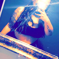 Stylish Female Model Captured in Bathroom Mirror