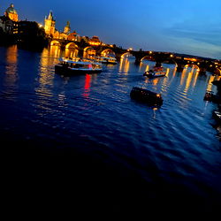 Riverfront Scene with Iconic Bridge at Night