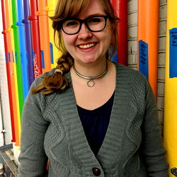 Julie, a Minneapolis Artist Poses in Front of a Colorful Pipe Art Installation