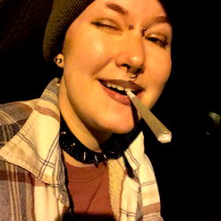 Angel, Smiling at Camera with Cigarette in Mouth