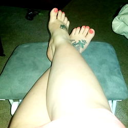 Sultry Feet in Trendy Tattoos: A Model Moment