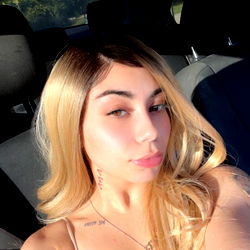 Model in a convertible with beachy waves