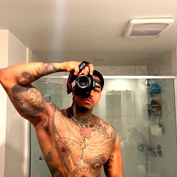 Alejandro from Los Angeles, a Tattooed Fitness Model Poses with his Camera and Biceps