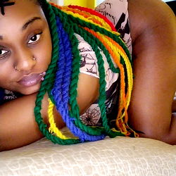 IttyBittyMoe in Colorful Braids on a Bed