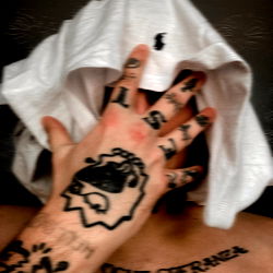 Singer J: Covered in Tattoos, Touching Face with Hoodie