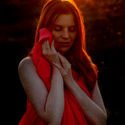 Leona Mur in Red Dress, Hand on Chest
