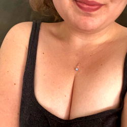 A Woman in a Black Tank Top Smiling at the Camera