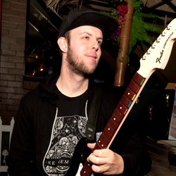 Guitarist with beard holding guitar