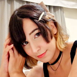 A young woman with a chic hairstyle posing for the camera