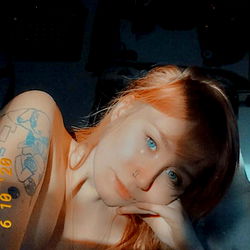 A Portrait of Sophie Lee, a Model with a Tattoo and Blue Eyes