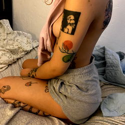 OnlyFans model Jessica showcasing her tattoos in a cozy setting